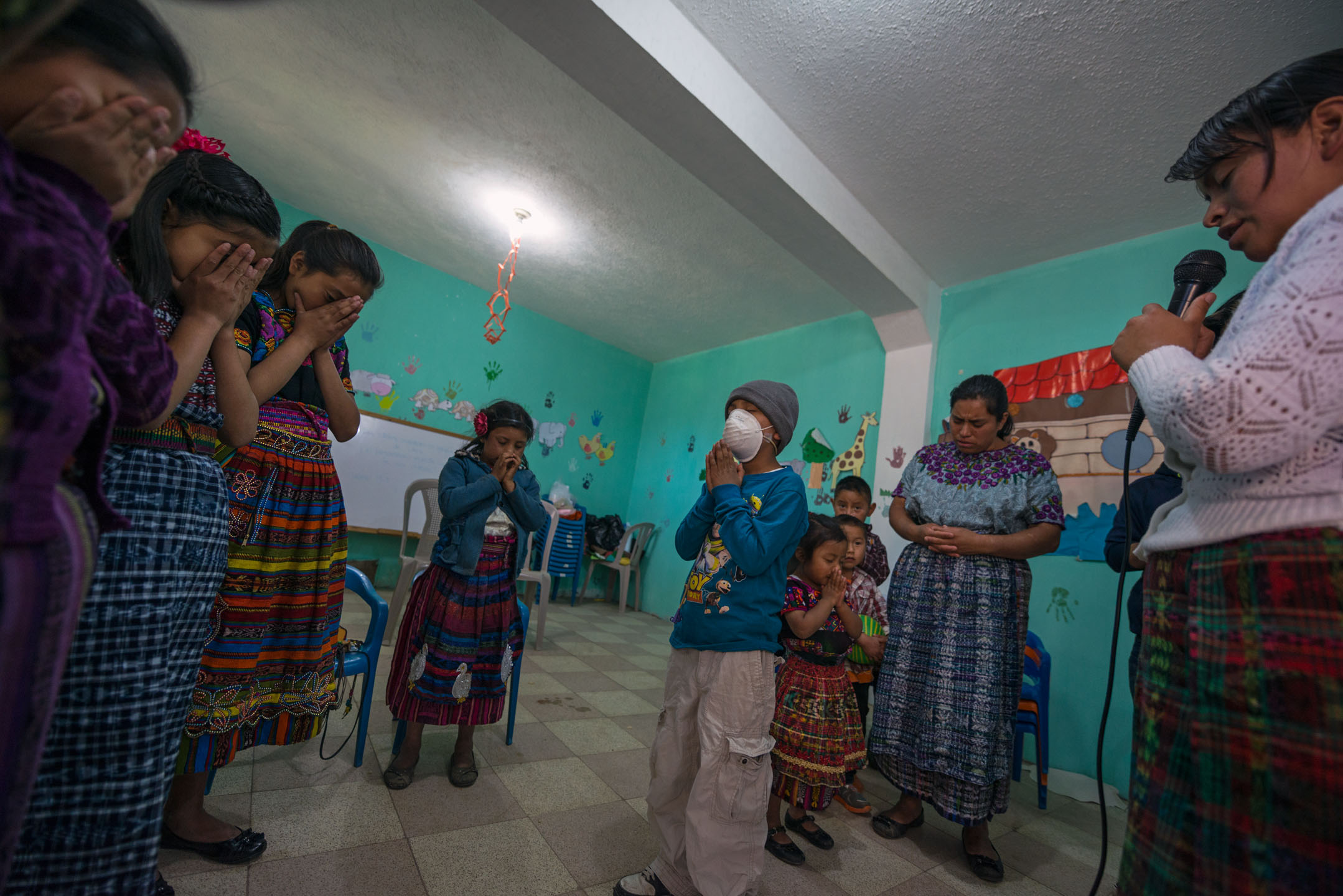 Heber stands in a prayer circle at Iglesia de Dios Evangelio Completo (Full Gospel Church of God) in his village, his first time attending Sunday School classes since being diagnosed with cancer the previous March.