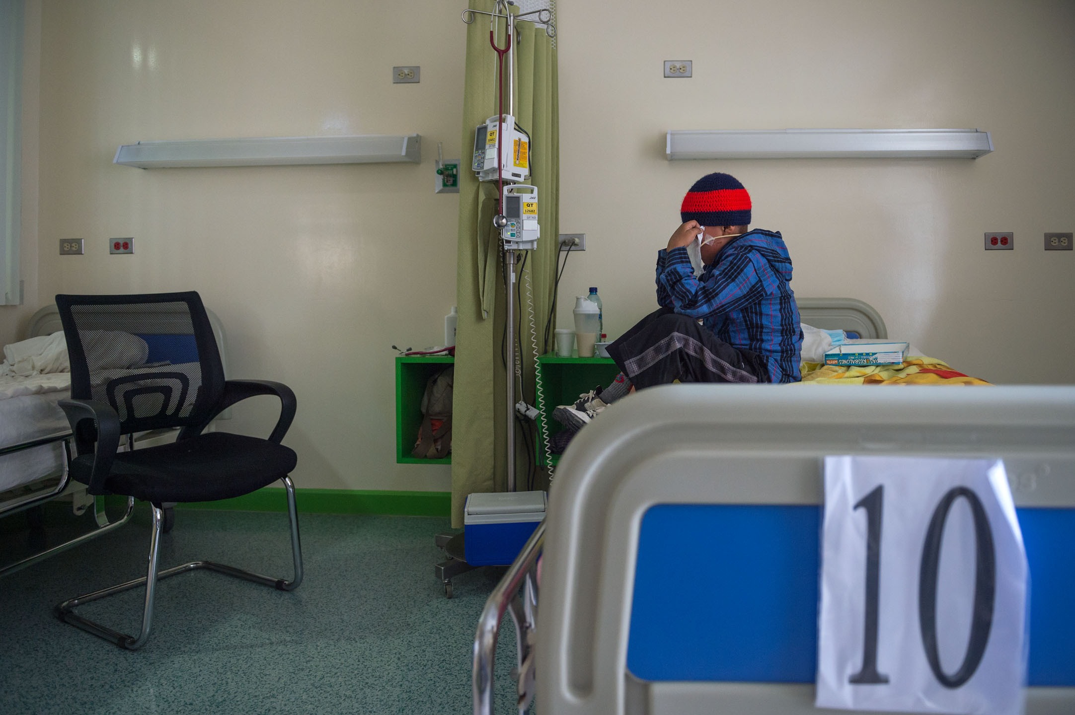 Heber has an emotional moment on his hospital bed as he and his father (not pictured) prepare to leave Unidad Nacional de Oncologia Pediatrica (UNOP) in Guatemala City for the long trip back to their home in San Cristobal, Totonicapan, Guatemala.