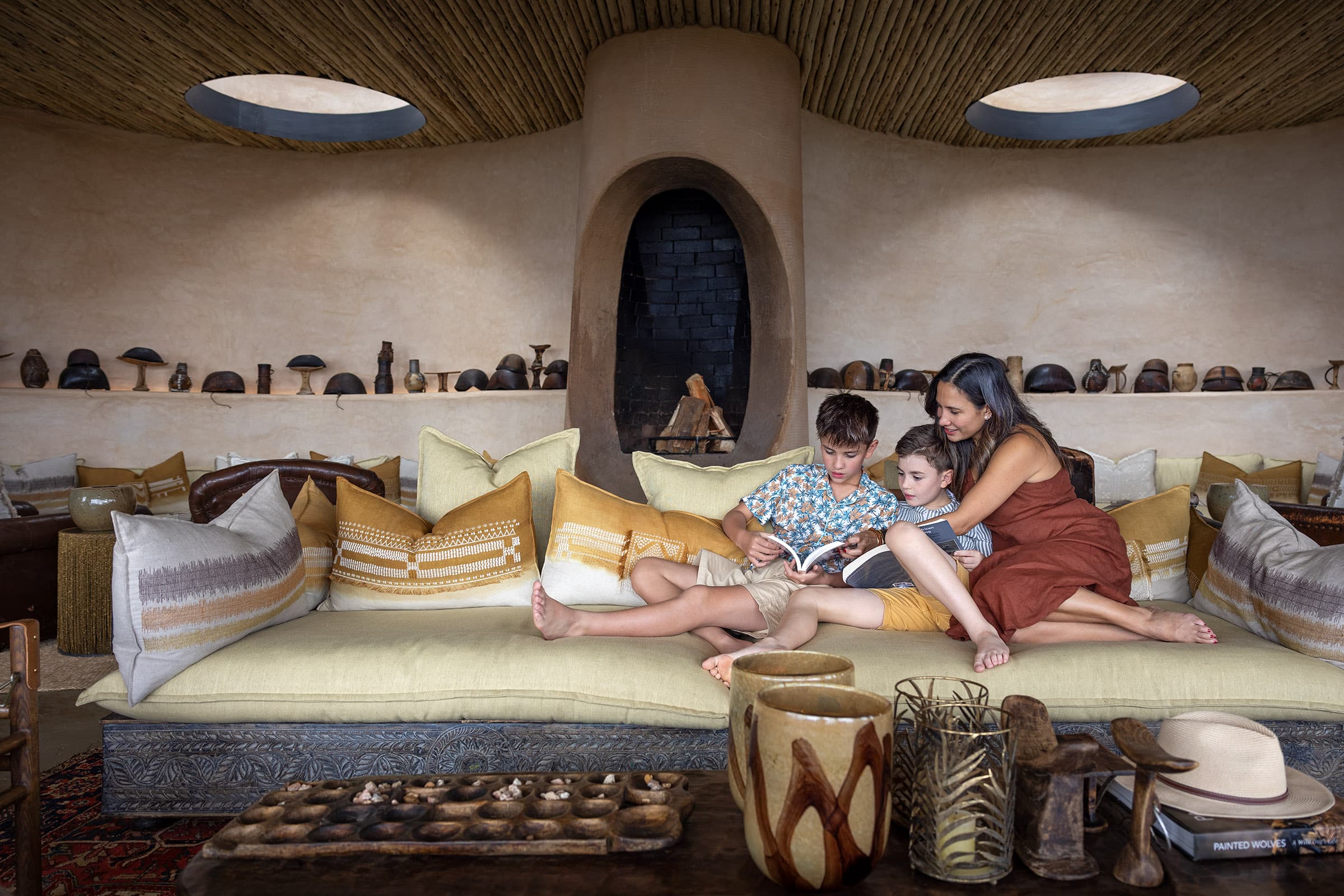 Stephanie Zubiri and her sons reading together at andBeyond Suyian in Laikipia, Kenya photographed by Scott A. Woodward
